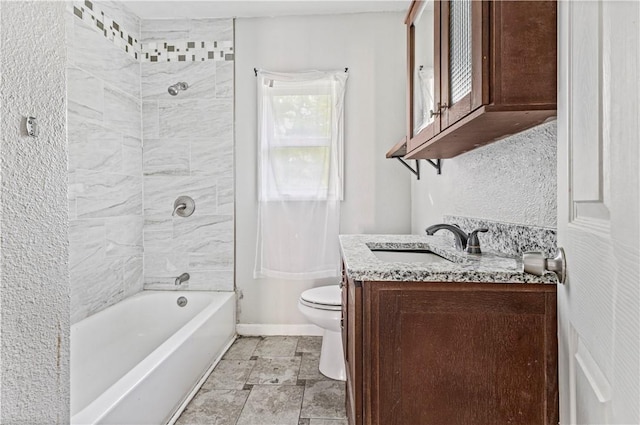 full bath featuring toilet, baseboards, shower / bathing tub combination, and vanity