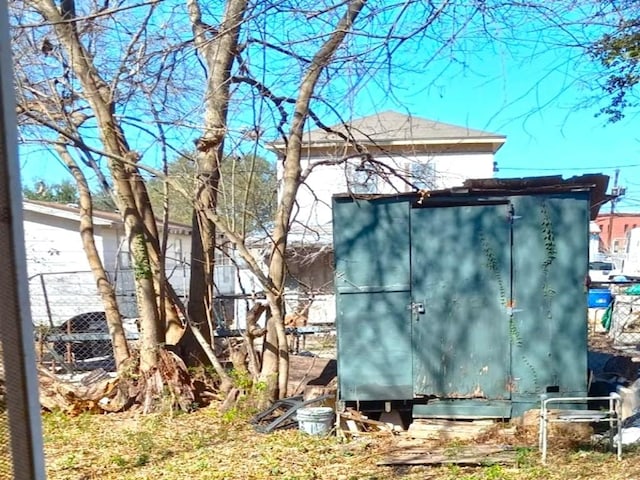 view of shed featuring fence