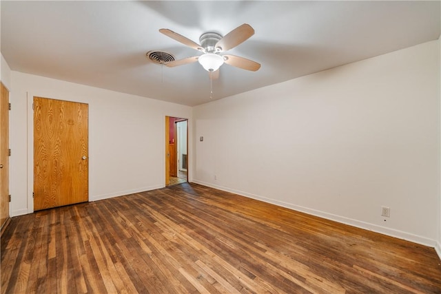 unfurnished bedroom with ceiling fan, dark hardwood / wood-style floors, and a closet