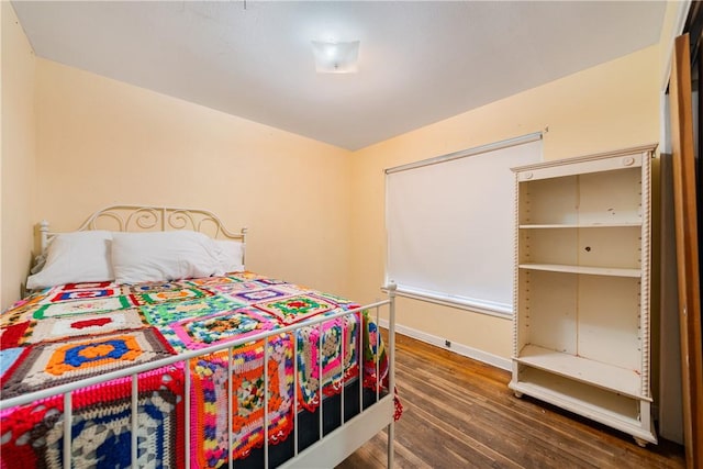 bedroom with dark hardwood / wood-style flooring