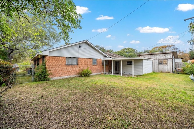 back of house with a lawn