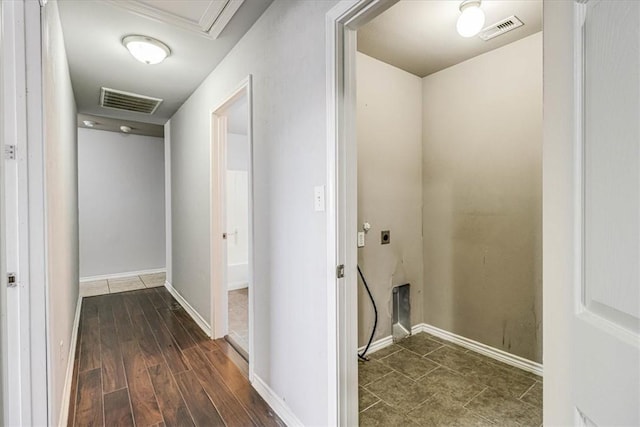 hall featuring dark wood-style flooring, visible vents, and baseboards