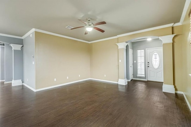 unfurnished living room featuring arched walkways, ceiling fan, dark wood finished floors, and ornate columns