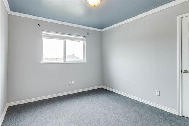 carpeted spare room featuring baseboards and crown molding