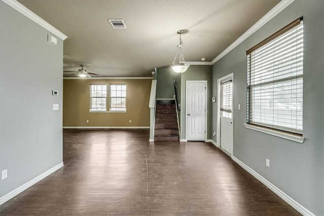 interior space featuring baseboards, visible vents, dark wood finished floors, stairway, and ornamental molding