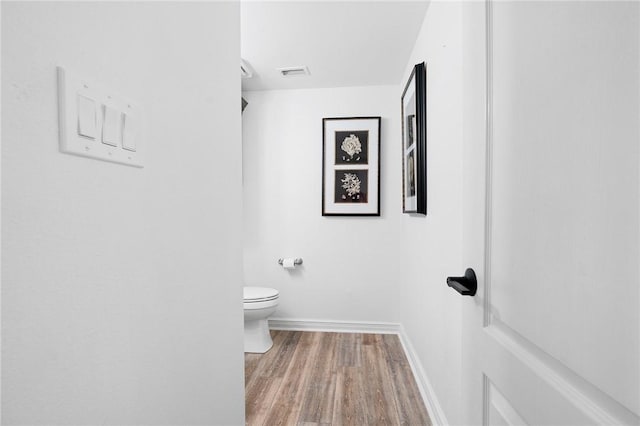 4589 Teal Dr, Corpus Christi, TX 78410 - bathroom featuring toilet, wood finished floors, baseboards, and visible vents