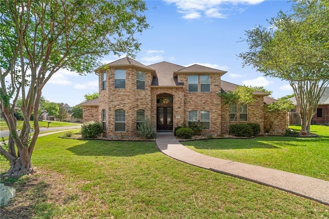 4589 Teal Dr, Corpus Christi, TX 78410 - traditional-style home featuring french doors, a front yard, and brick siding