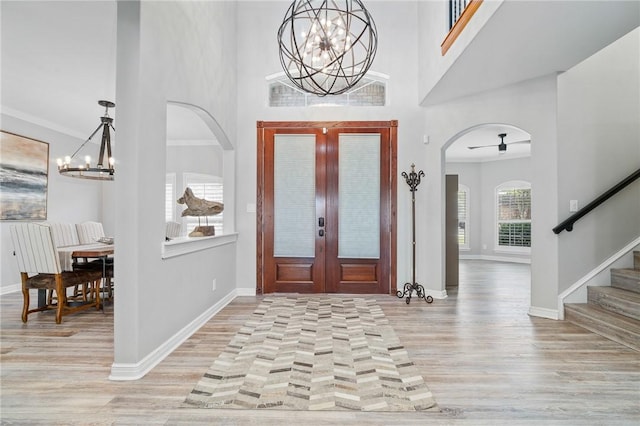 4589 Teal Dr, Corpus Christi, TX 78410 - entryway with an inviting chandelier, stairway, a high ceiling, light wood finished floors, and baseboards