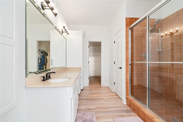 4589 Teal Dr, Corpus Christi, TX 78410 - bathroom featuring a spacious closet, vanity, a stall shower, and wood finished floors