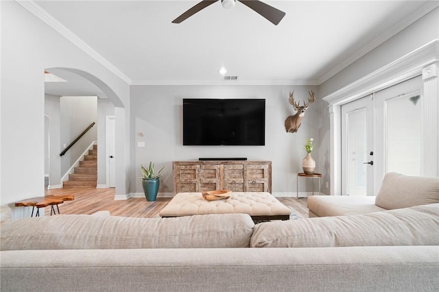 4589 Teal Dr, Corpus Christi, TX 78410 - living area featuring crown molding, ceiling fan, arched walkways, wood finished floors, and baseboards
