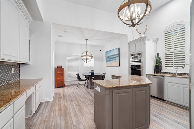 4589 Teal Dr, Corpus Christi, TX 78410 - kitchen with a sink, decorative backsplash, an inviting chandelier, and stainless steel appliances
