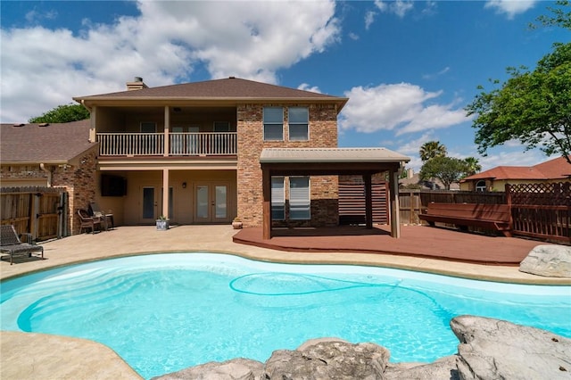 4589 Teal Dr, Corpus Christi, TX 78410 - back of property with a fenced in pool, a balcony, french doors, a patio area, and fence