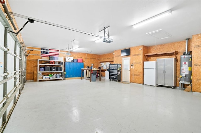 4589 Teal Dr, Corpus Christi, TX 78410 - garage with a garage door opener, freestanding refrigerator, and water heater