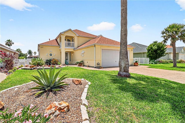 973 Pompano Dr, Aransas Pass, TX 78336 - mediterranean / spanish home featuring stucco siding, a balcony, driveway, and an attached garage