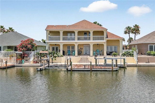 973 Pompano Dr, Aransas Pass, TX 78336 - rear view of property featuring a balcony, a water view, stucco siding, and french doors