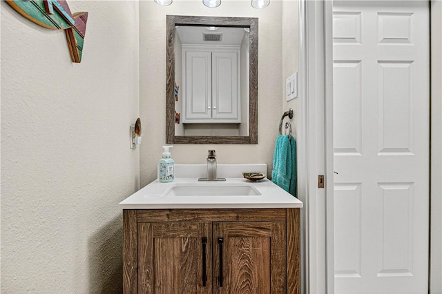 973 Pompano Dr, Aransas Pass, TX 78336 - bathroom featuring vanity and a textured wall