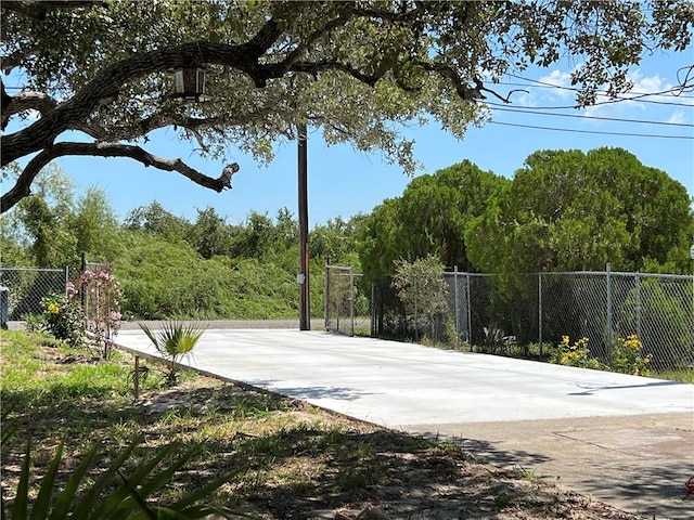 view of basketball court with fence