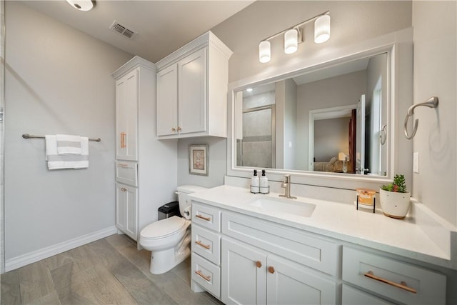 6421 Aikman, Corpus Christi, TX 78414 - ensuite bathroom featuring vanity, toilet, a shower with door, wood finished floors, and baseboards