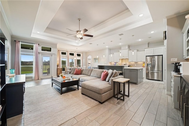 6421 Aikman, Corpus Christi, TX 78414 - living room featuring a tray ceiling, ceiling fan, recessed lighting, and crown molding