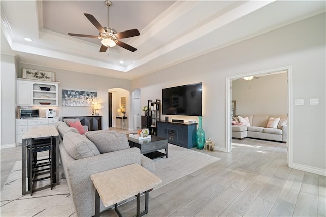6421 Aikman, Corpus Christi, TX 78414 - living area with a raised ceiling, arched walkways, ceiling fan, ornamental molding, and baseboards