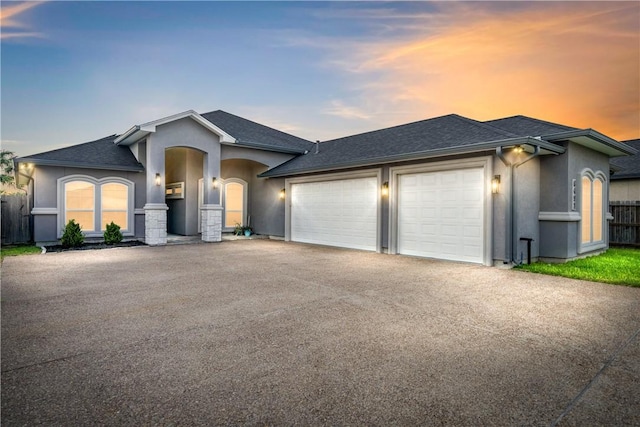 6421 Aikman, Corpus Christi, TX 78414 - view of front of property with a garage, asphalt driveway, stucco siding, and roof with shingles