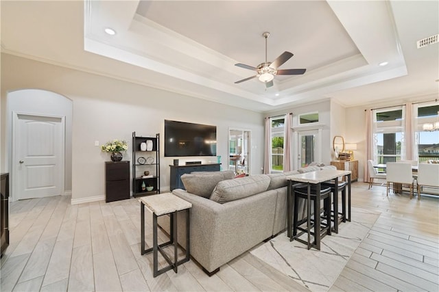 6421 Aikman, Corpus Christi, TX 78414 - living room with a raised ceiling, a ceiling fan, light wood-style flooring, arched walkways, and recessed lighting