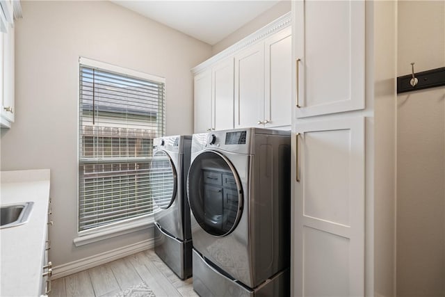 6421 Aikman, Corpus Christi, TX 78414 - washroom with cabinet space, washer and dryer, and baseboards