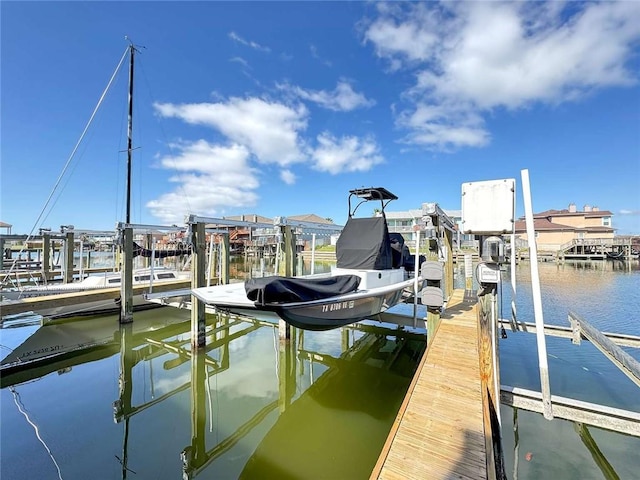 view of dock with boat lift and a water view