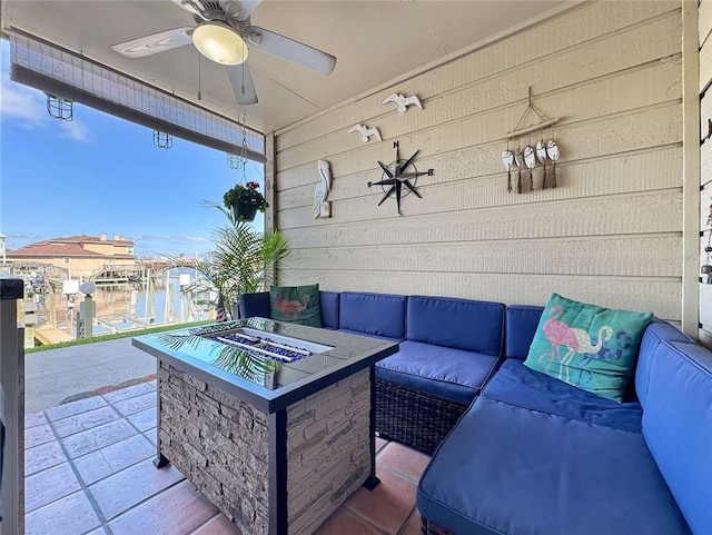 view of patio / terrace with an outdoor living space with a fire pit and ceiling fan