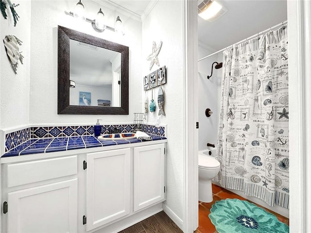full bathroom featuring toilet, ornamental molding, and vanity