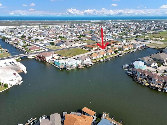 drone / aerial view featuring a water view and a residential view