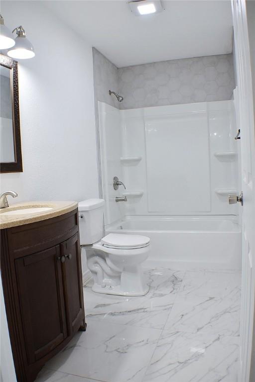 1517 E Warren Ave, Kingsville, TX 78363 - full bath with shower / bathtub combination, toilet, marble finish floor, and vanity
