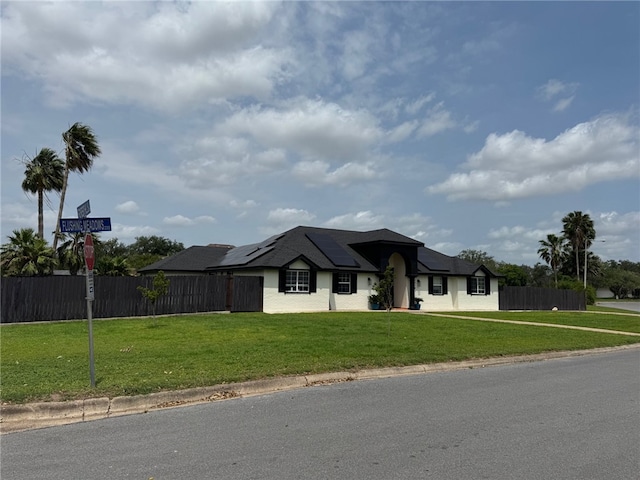 view of front of home with roof mounted solar panels