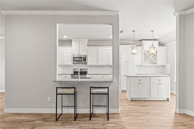 4241 Aaron Cv, Corpus Christi, TX 78413 - kitchen featuring stainless steel appliances, decorative backsplash, light wood-style flooring, white cabinetry, and ornamental molding