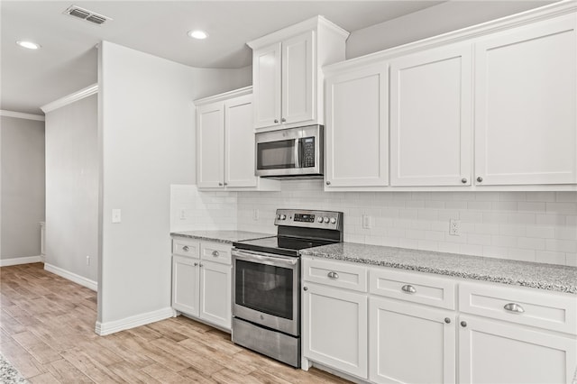 4241 Aaron Cv, Corpus Christi, TX 78413 - kitchen featuring appliances with stainless steel finishes, ornamental molding, white cabinetry, backsplash, and recessed lighting