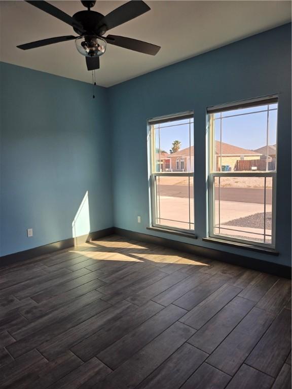 16125 Seagrape St, Corpus Christi, TX 78418 - empty room with dark wood finished floors and a ceiling fan