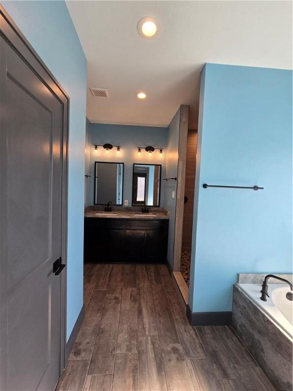 16125 Seagrape St, Corpus Christi, TX 78418 - full bath with a garden tub, double vanity, and wood finished floors