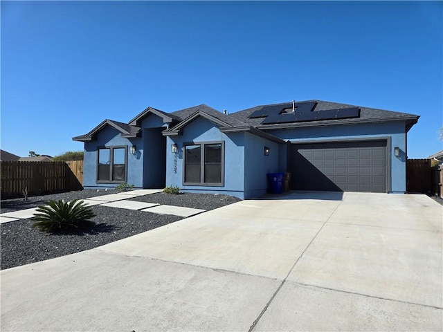 view of front of property with solar panels and a garage