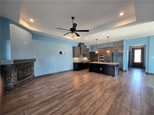 16125 Seagrape St, Corpus Christi, TX 78418 - kitchen with a raised ceiling, light countertops, an island with sink, double oven, and ceiling fan