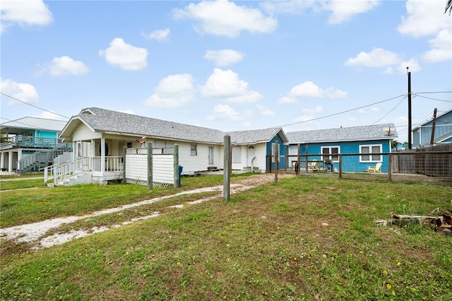 rear view of property with a yard