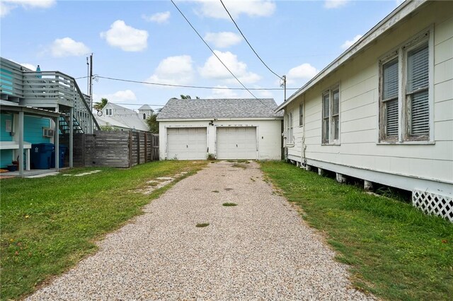 217 E Brundrett Ave, Port Aransas, TX 78373 - view of home's exterior with a garage and an outdoor structure