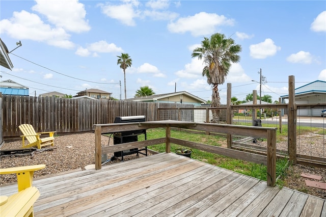 wooden deck featuring a grill