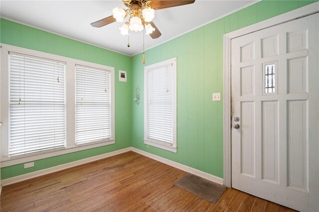 217 E Brundrett Ave, Port Aransas, TX 78373 - foyer entrance with baseboards, a ceiling fan, wood finished floors, and ornamental molding