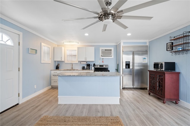 kitchen with crown molding, white cabinets, stainless steel appliances, and light wood-type flooring