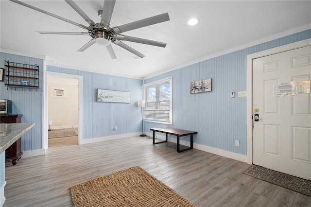 foyer with ceiling fan, light hardwood / wood-style floors, and ornamental molding