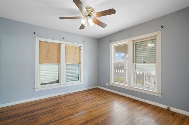 spare room with ceiling fan and wood-type flooring