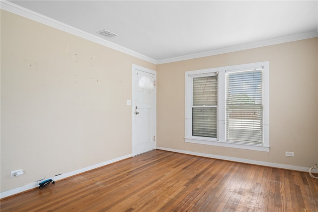 spare room with wood-type flooring and ornamental molding