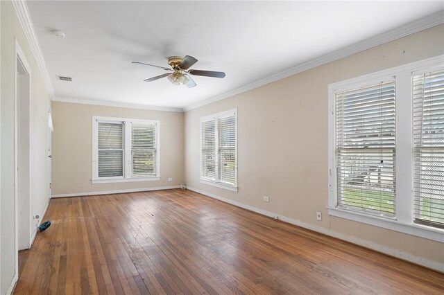 217 E Brundrett Ave, Port Aransas, TX 78373 - unfurnished room featuring a ceiling fan, wood-type flooring, baseboards, and crown molding