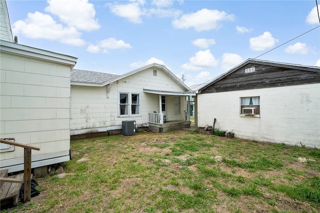 back of house featuring a lawn and cooling unit