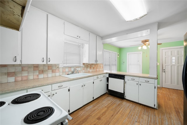 kitchen with white appliances, light hardwood / wood-style floors, white cabinetry, and sink